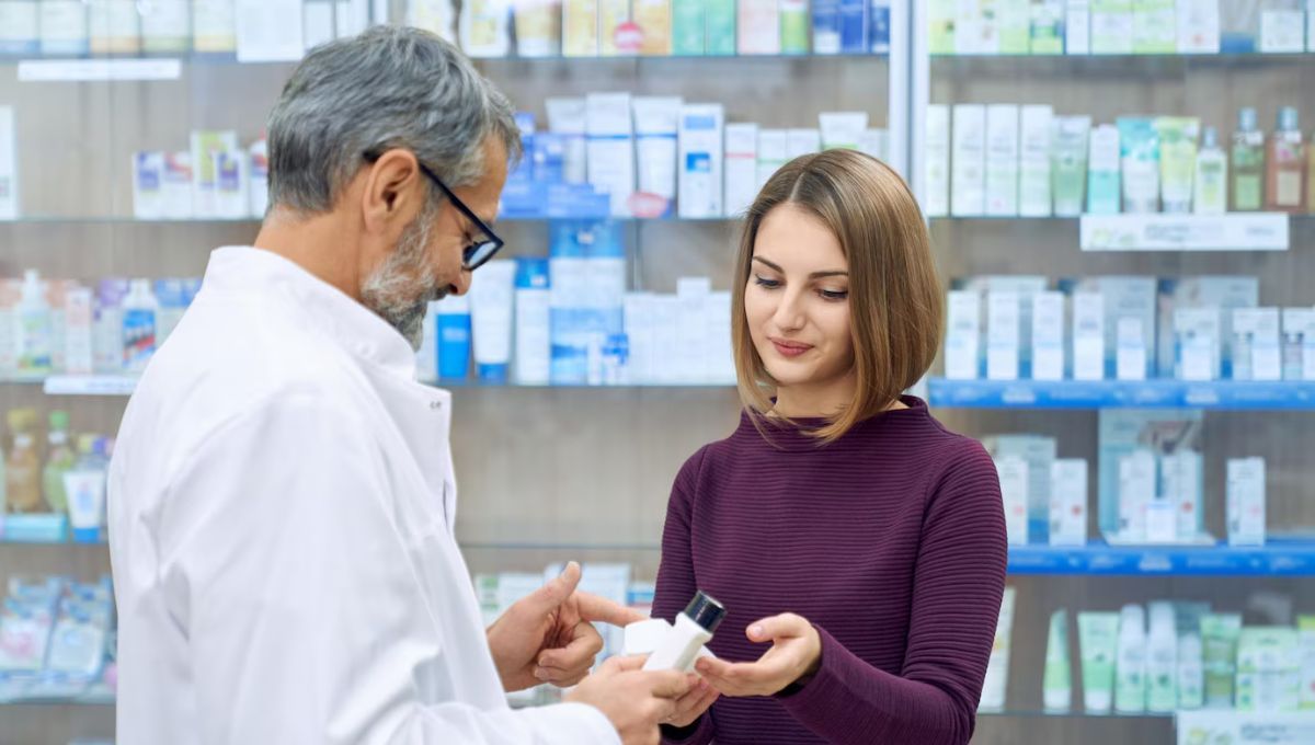 Farmacéutico con una clienta en la farmacia (Fuente: Canva)